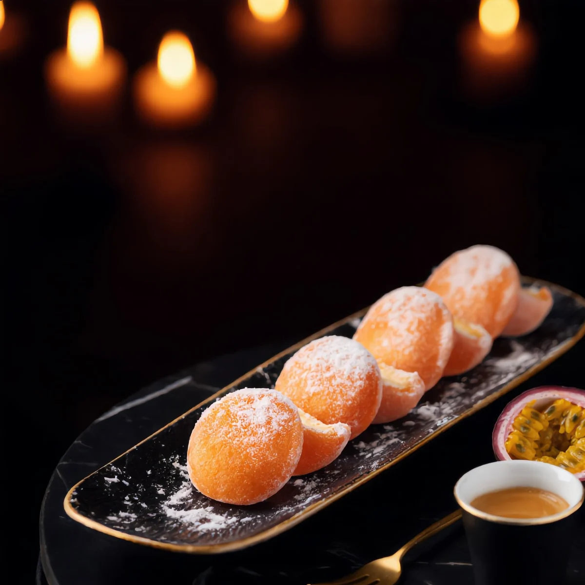 Passion Fruit mini mochi served on a black plate with espresso